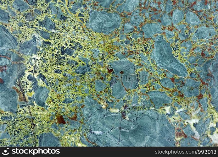 Backgrounds and textures: surface of beautiful green decorative stone, abstract pattern of cracks, spots and stains, natural background. Abstract mineral texture