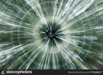 Backgrounds and textures: surface of beautiful green decorative stone, Clinochlore, abstract pattern of concentric circles and radial cracks, spots and stains, natural background. Abstract mineral texture