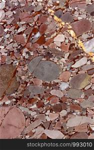Backgrounds and textures: surface of beautiful pink decorative stone, abstract pattern of cracks, spots and stains, natural background. Abstract mineral texture