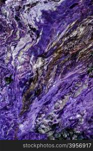 Backgrounds and textures: surface of beautiful purple decorative stone, abstract pattern of swirls, twirls, lines, cracks, spots and stains, natural background