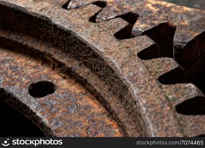Backgrounds and textures: two connected steel cogwheels, very old and rusty, close-up shot, industrial abstract. Old and rusty cogwheels