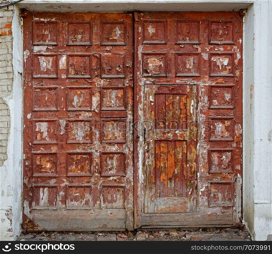 Backgrounds and textures: very old gateway, closed doors, aged cracky paint. Very old gateway