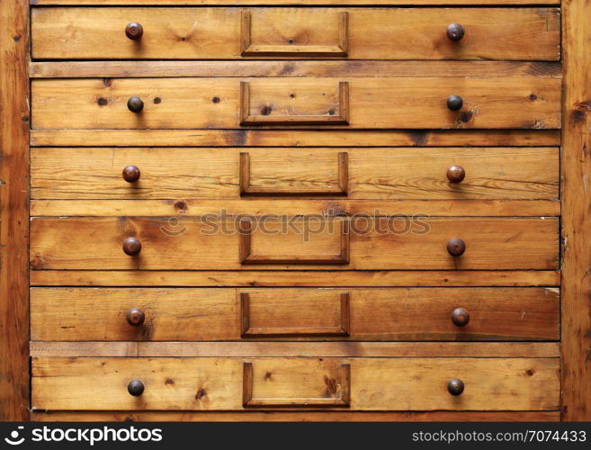 Backgrounds and textures: very old wooden cabinet with drawers. Wooden cabinet with drawers