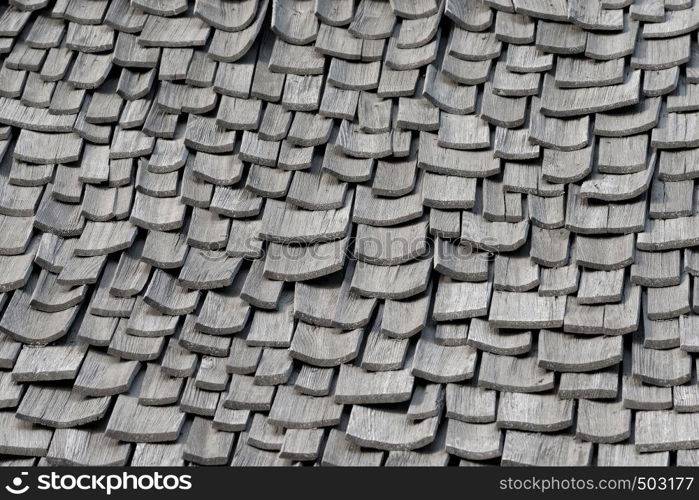 Backgrounds and textures: weathered wooden shingles, exterior wall or roof of rustic building. Old weathered wooden shingles