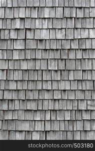 Backgrounds and textures: weathered wooden shingles, exterior wall or roof of rustic building. Old weathered wooden shingles
