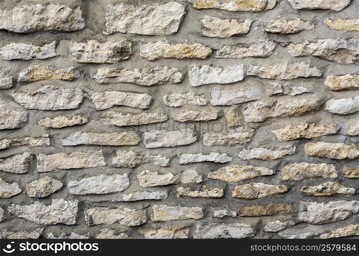 Backgrounds - stone wall on the side of a house built in local Yorkshire Stone - Yorkshire, northeast England.