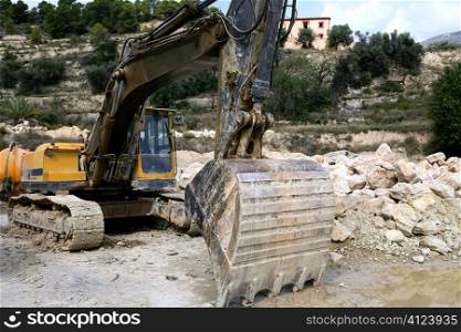 Backhoe bulldozer working hard with stones