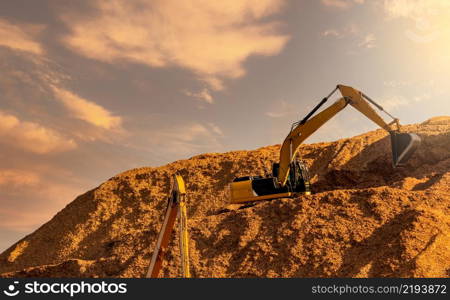 Backhoe working on huge sawdust pile in paper production factory. Bucket of digger digging wood chips. Pile of wood chips from pulp mill against the sky. Pulp and paper industry. Bulldozer working.