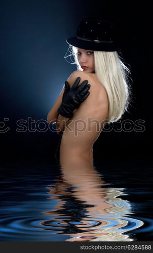 backlight image of black hat girl in water