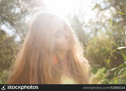 Backlit image of the pretty blonde outdoors. Colorized image