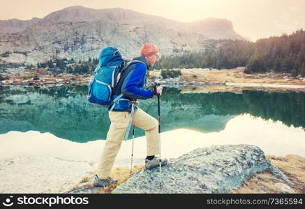 Backpacker in a hike in the summer mountains