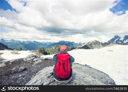 Backpacker in a hike in the summer mountains