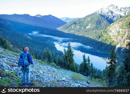 Backpacker in a hike in the summer mountains