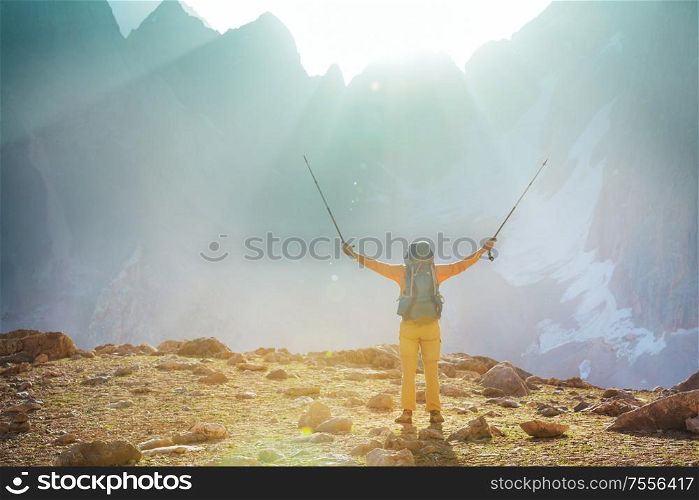 Backpacker in a hike in the summer mountains