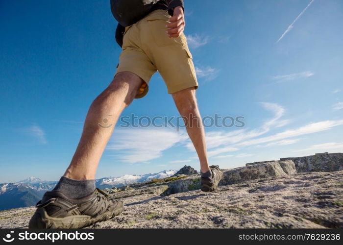 Backpacker in a hike in the summer mountains