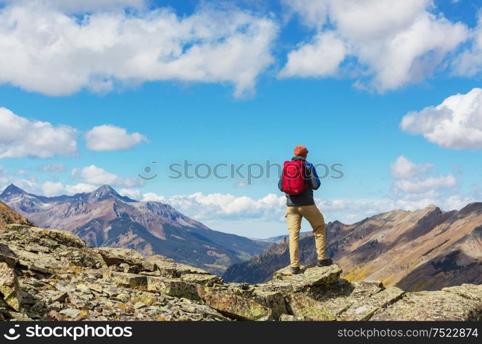 Backpacker in hike in the autumn mountains