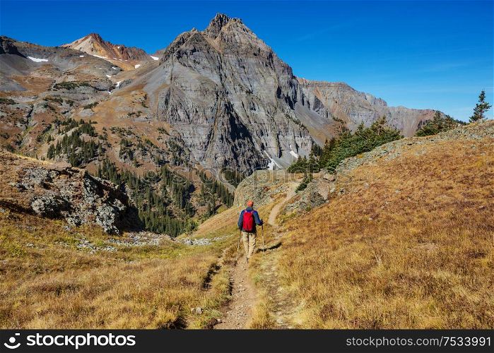 Backpacker in hike in the autumn mountains