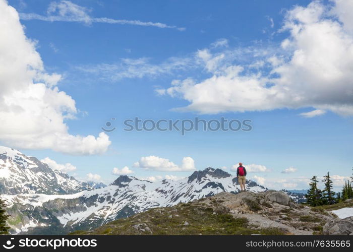 Backpacker in hike in the high mountains