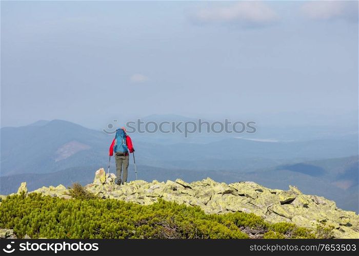 Backpacker in hike in the high mountains