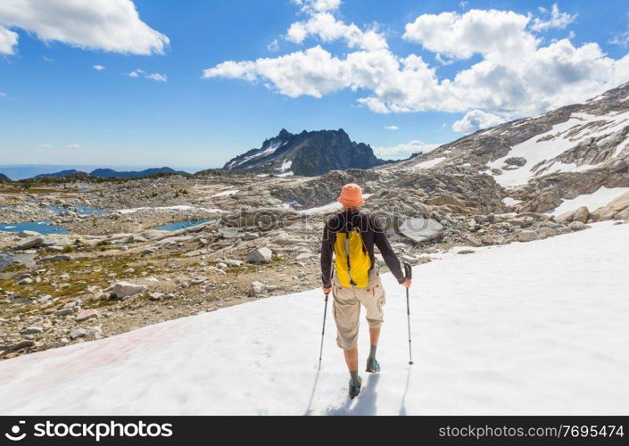 Backpacker in hike in the high mountains