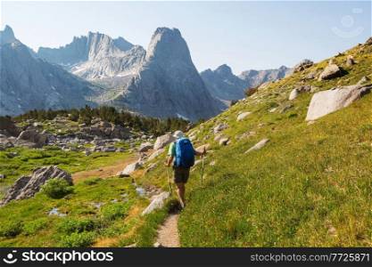 Backpacker in hike in the high mountains