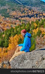 Backpacker man hiking at Artist&rsquo;s Bluff in autumn. Fall colours in Franconia Notch State Park. White Mountain National Forest, New Hampshire, USA