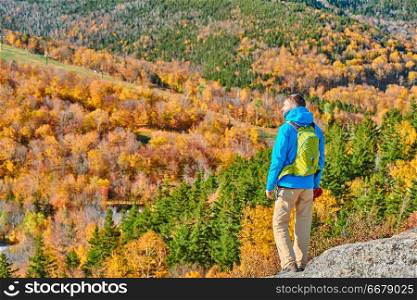 Backpacker man hiking at Artist&rsquo;s Bluff in autumn. Fall colours in Franconia Notch State Park. White Mountain National Forest, New Hampshire, USA