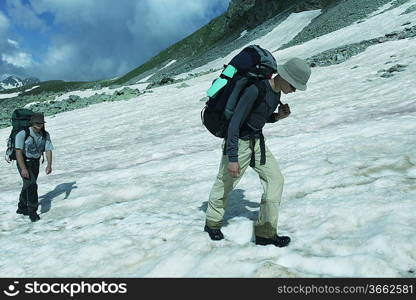 Backpackers on mountains lake