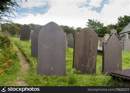 Backs of gravestones, made from dark blue slate. Menai Bridge, Anglesey, Wales, United Kingdom.