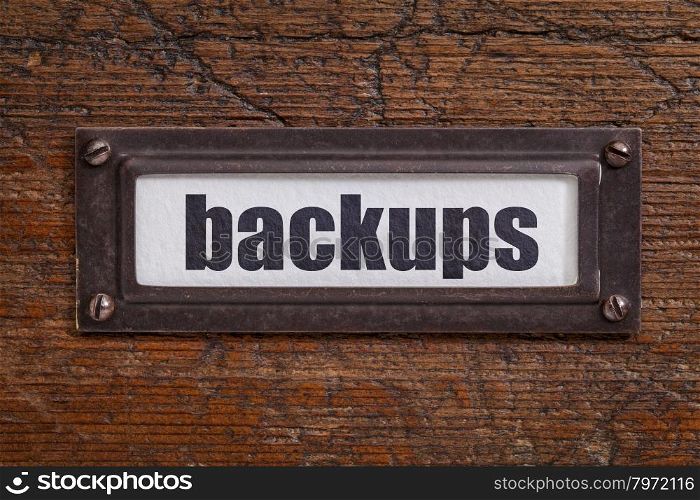 backups - a label on a grunge wooden file cabinet