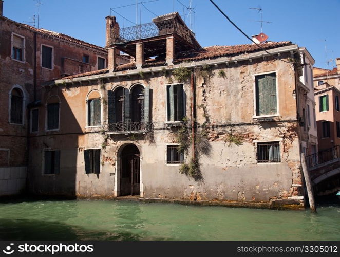 Backwater in Venice showing small canal and old building