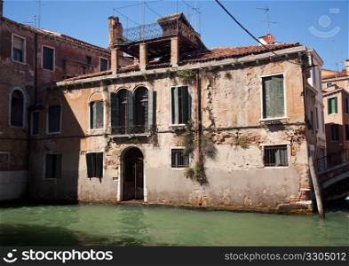 Backwater in Venice showing small canal and old building