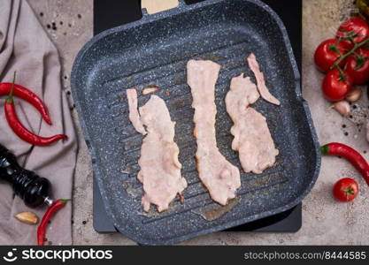 Bacon Being Cooked in grill frying pan Skillet at domestic kitchen.. Bacon Being Cooked in grill frying pan Skillet at domestic kitchen