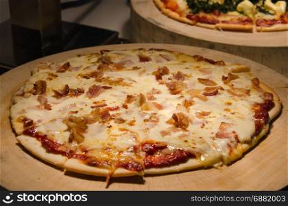 Bacon cheese pizza on a wood.