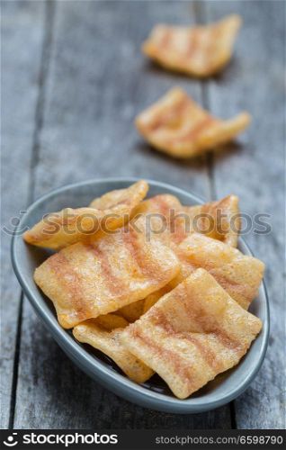 Bacon chips on gray rustic wood.. Bacon chips on gray rustic wood