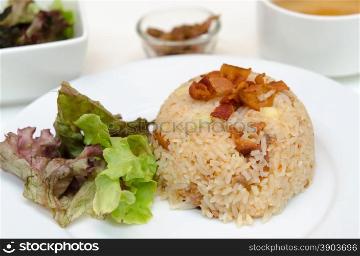 Bacon fried rice with chili on dish.