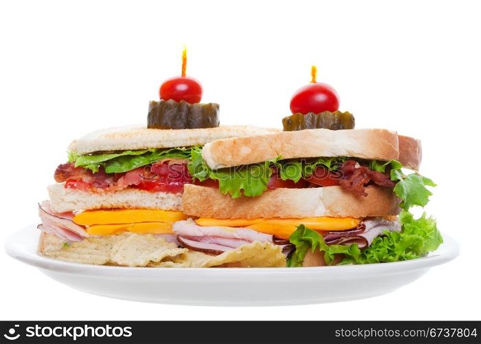 Bacon ham and cheese club sandwich with chips isolated on white background