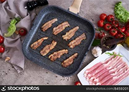 Bacon slices fying on grill frying pan Skillet at domestic kitchen.. Bacon slices fying on grill frying pan Skillet at domestic kitchen