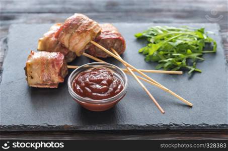 Bacon-wrapped beef skewers stuffed with mozzarella