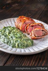 Bacon-wrapped beef steack with creamed spinach