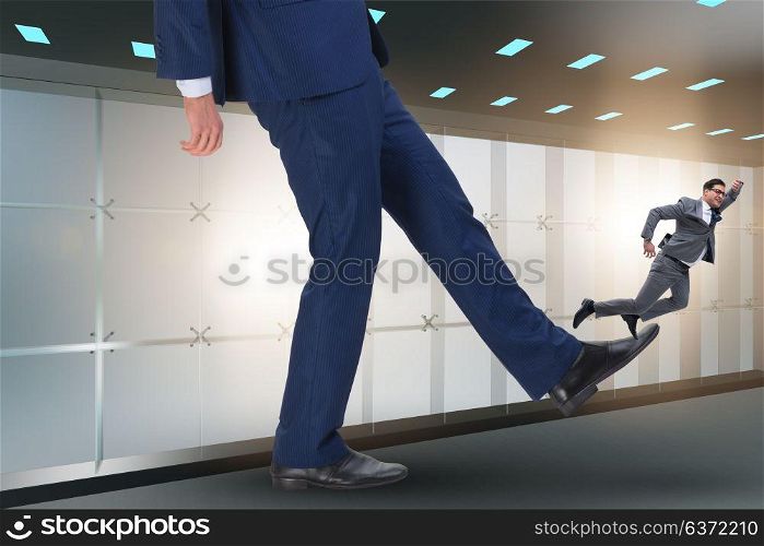 Bad angry boss kicking employee in business concept