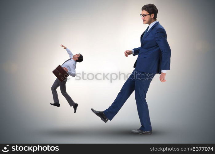 Bad angry boss kicking employee in business concept