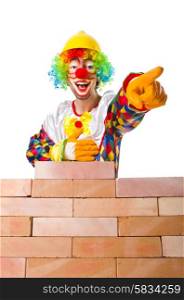 Bad construction concept with clown laying bricks