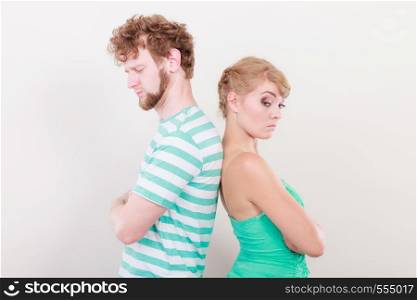 Bad relationship concept. Man and woman in disagreement. Young couple after quarrel offended back to back, not speaking to each other