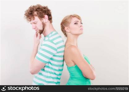 Bad relationship concept. Man and woman in disagreement. Young couple after quarrel offended back to back, not speaking to each other