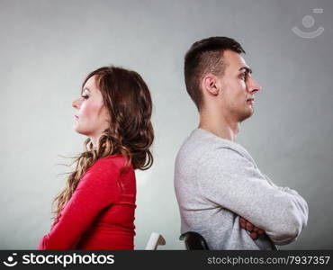 Bad relationship concept. Man and woman in disagreement. Young couple after quarrel sitting on chairs back to back