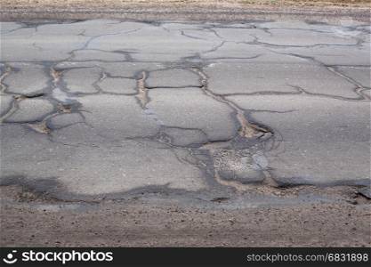 Bad road for cars with cracks.