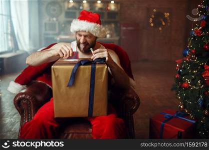 Bad Santa claus takes drugs, nasty cocaine party, humor. Unhealthy lifestyle, bearded man in holiday costume, new year and alcoholism. Bad Santa claus takes drugs, cocaine party, humor