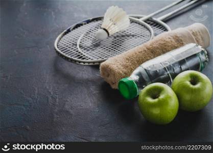 badminton rackets with apples water bottle