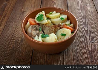 Baeckeoffe - ypical dish from French , Germany.mix of sliced potatoes, sliced onions, cubed mutton, beef and pork